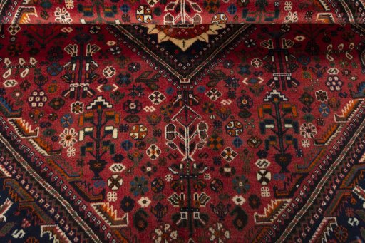 Corner detail of 2000s Shiraz rug showing border pattern and Wool pile