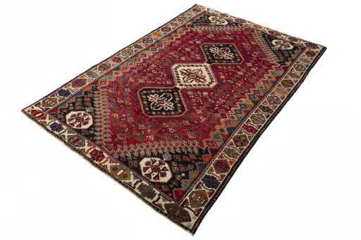 Corner detail of 2000s Shiraz rug showing border pattern and Wool pile