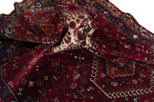 Corner detail of 2000s Shiraz rug showing border pattern and Wool pile