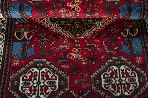Corner detail of 2000s Shiraz rug showing border pattern and Wool pile