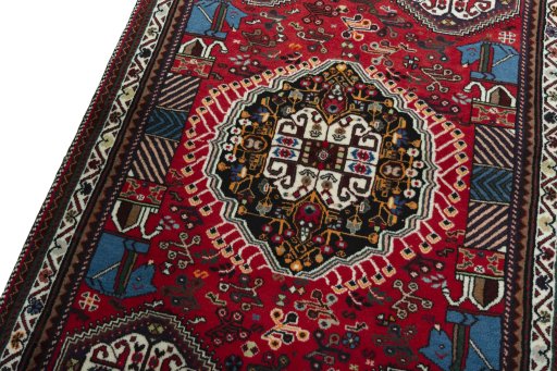 Backside of handmade 2000s Shiraz rug showing knot structure and weave density
