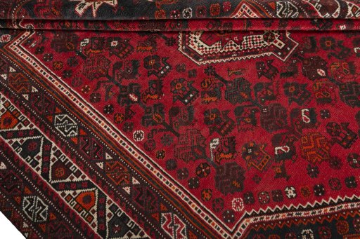 Corner detail of 2000s Shiraz rug showing border pattern and Wool pile