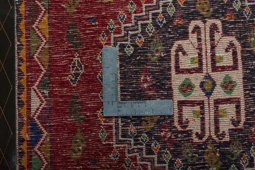 Backside of handmade 2000s Shiraz rug showing knot structure and weave density