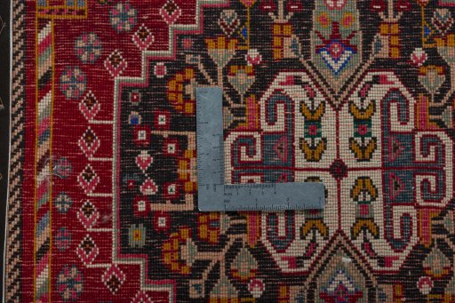 Backside of handmade 2000s Shiraz rug showing knot structure and weave density