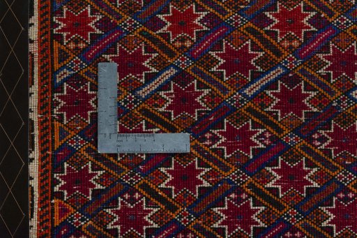 Backside of handmade 2000s Shiraz rug showing knot structure and weave density