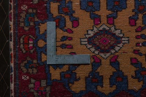 Backside of handmade 2000s Shiraz rug showing knot structure and weave density