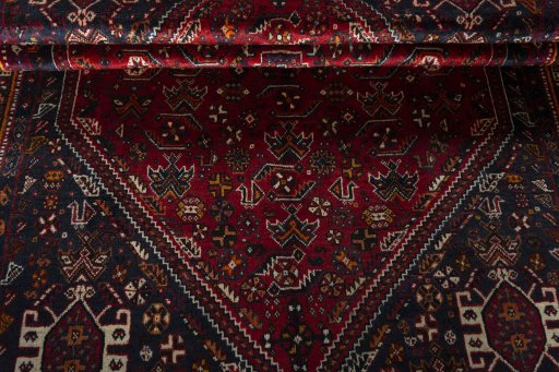 Corner detail of 2000s Shiraz rug showing border pattern and Wool pile