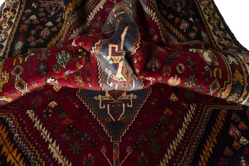 Corner detail of 2000s Shiraz rug showing border pattern and Wool pile
