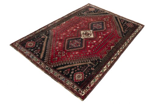 Corner detail of 2000s Shiraz rug showing border pattern and Wool pile