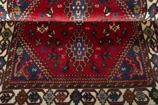 Corner detail of 2000s Shiraz rug showing border pattern and Wool pile