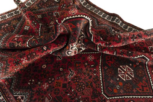 Corner detail of 2000s Shiraz rug showing border pattern and Wool pile