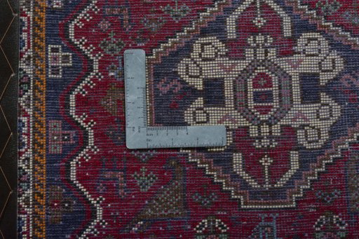 Backside of handmade 2000s Shiraz rug showing knot structure and weave density