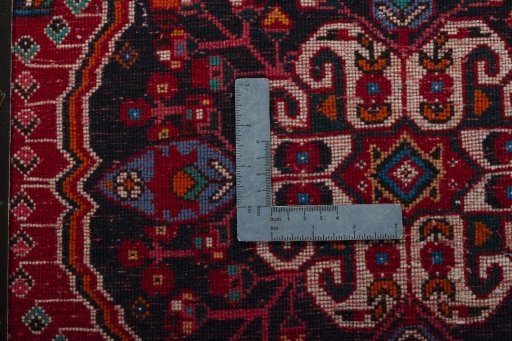 Backside of handmade 2000s Shiraz rug showing knot structure and weave density