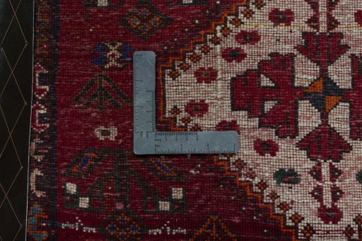 Backside of handmade 2000s Shiraz rug showing knot structure and weave density