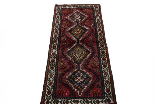 Surface texture of 2000s Shiraz rug with natural Wool and intricate pattern