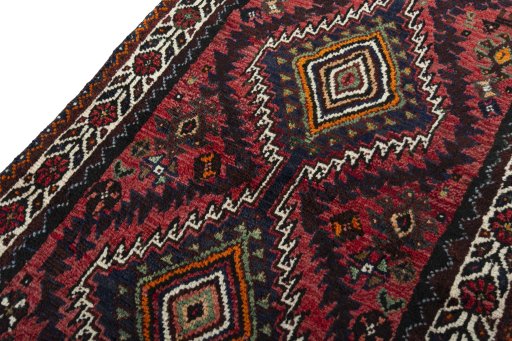 Backside of handmade 2000s Shiraz rug showing knot structure and weave density