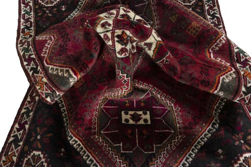 Corner detail of 2000s Shiraz rug showing border pattern and Wool pile