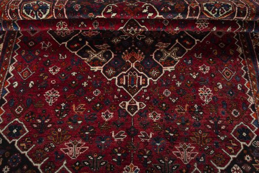 Corner detail of 2000s Shiraz rug showing border pattern and Wool pile