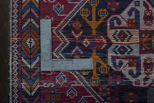 Backside of handmade 2000s Shiraz rug showing knot structure and weave density