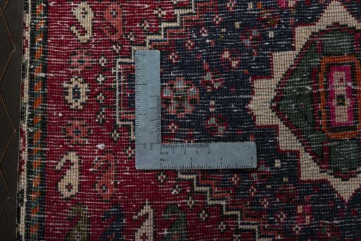 Backside of handmade 2000s Shiraz rug showing knot structure and weave density