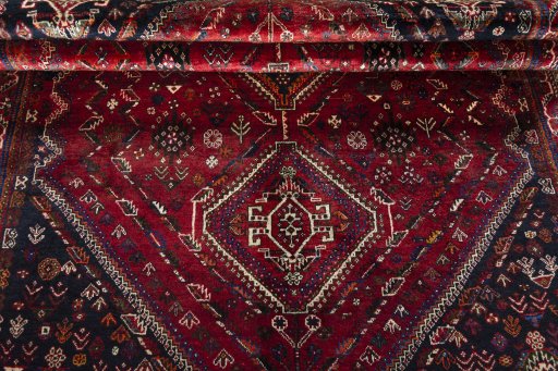 Corner detail of 2000s Shiraz rug showing border pattern and Wool pile