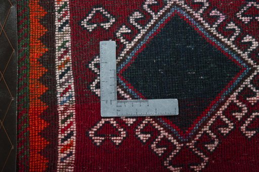Backside of handmade 2000s Shiraz rug showing knot structure and weave density
