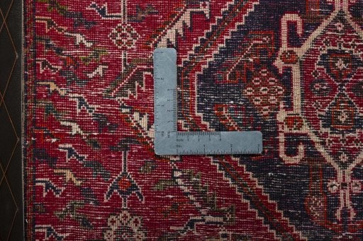 Backside of handmade 2000s Shiraz rug showing knot structure and weave density