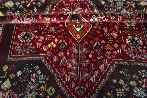 Corner detail of 2000s Shiraz rug showing border pattern and Wool pile