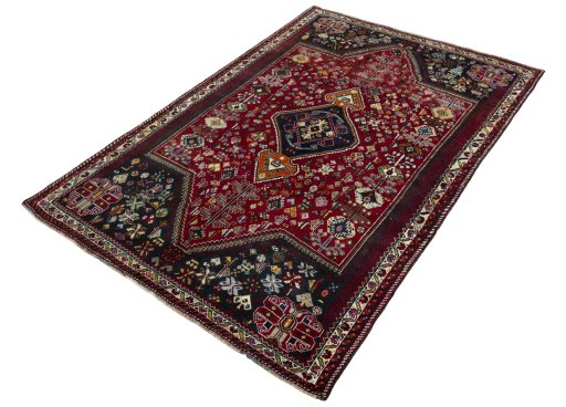 Corner detail of 2000s Shiraz rug showing border pattern and Wool pile
