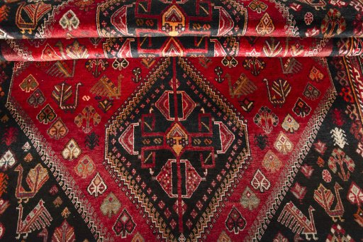 Corner detail of 2000s Shiraz rug showing border pattern and Wool pile