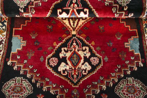 Corner detail of 2000s Shiraz rug showing border pattern and Wool pile