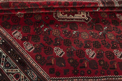 Corner detail of 2000s Shiraz rug showing border pattern and Wool pile