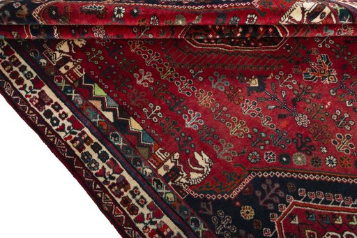 Corner detail of 2000s Shiraz rug showing border pattern and Wool pile