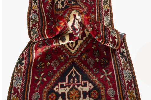 Corner detail of 2000s Shiraz rug showing border pattern and Wool pile
