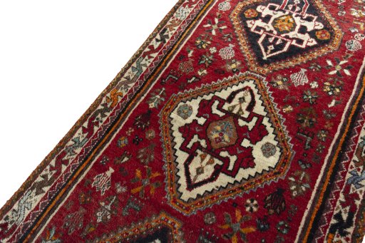 Backside of handmade 2000s Shiraz rug showing knot structure and weave density