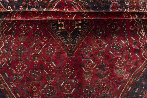Corner detail of 2000s Shiraz rug showing border pattern and Wool pile