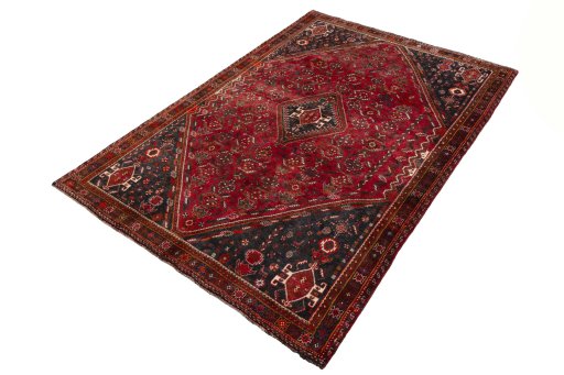 Corner detail of 2000s Shiraz rug showing border pattern and Wool pile