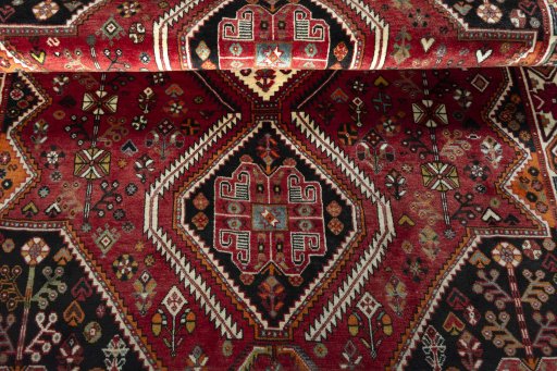 Corner detail of 2000s Shiraz rug showing border pattern and Wool pile