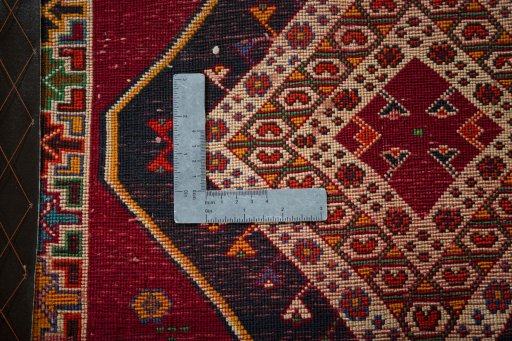 Backside of handmade 2000s Shiraz rug showing knot structure and weave density