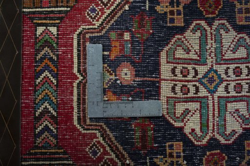Backside of handmade 2000s Shiraz rug showing knot structure and weave density