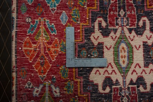Backside of handmade 2000s Shiraz rug showing knot structure and weave density