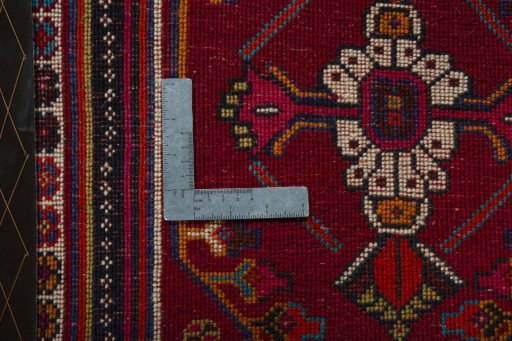 Backside of handmade 2000s Shiraz rug showing knot structure and weave density