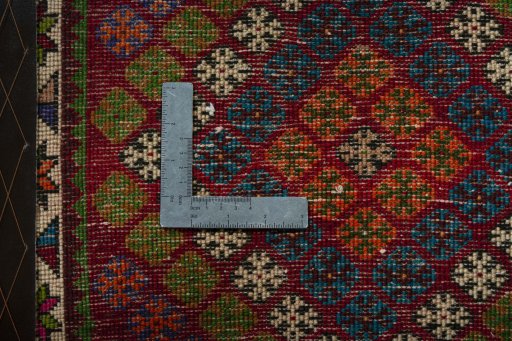 Backside of handmade 2000s Shiraz rug showing knot structure and weave density