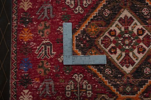 Backside of handmade 2000s Shiraz rug showing knot structure and weave density