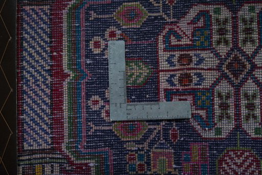 Backside of handmade 2000s Shiraz rug showing knot structure and weave density