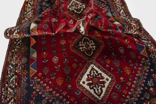 Corner detail of 2000s Shiraz rug showing border pattern and Wool pile