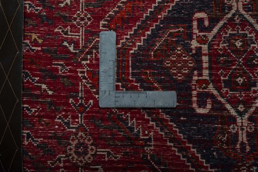 Backside of handmade 2000s Shiraz rug showing knot structure and weave density