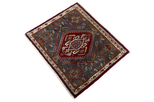 Corner detail of 2000s Shiraz rug showing border pattern and Wool pile