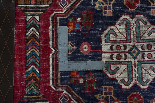 Backside of handmade 2000s Shiraz rug showing knot structure and weave density