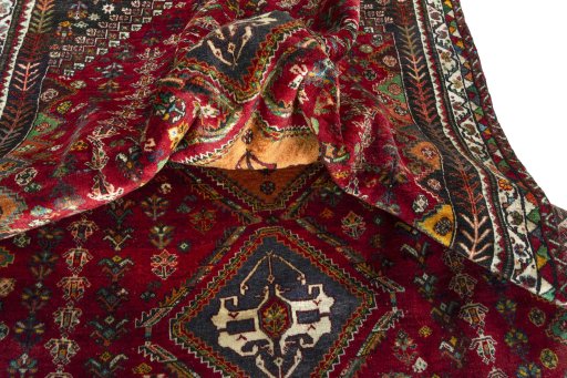 Corner detail of 2000s Shiraz rug showing border pattern and Wool pile